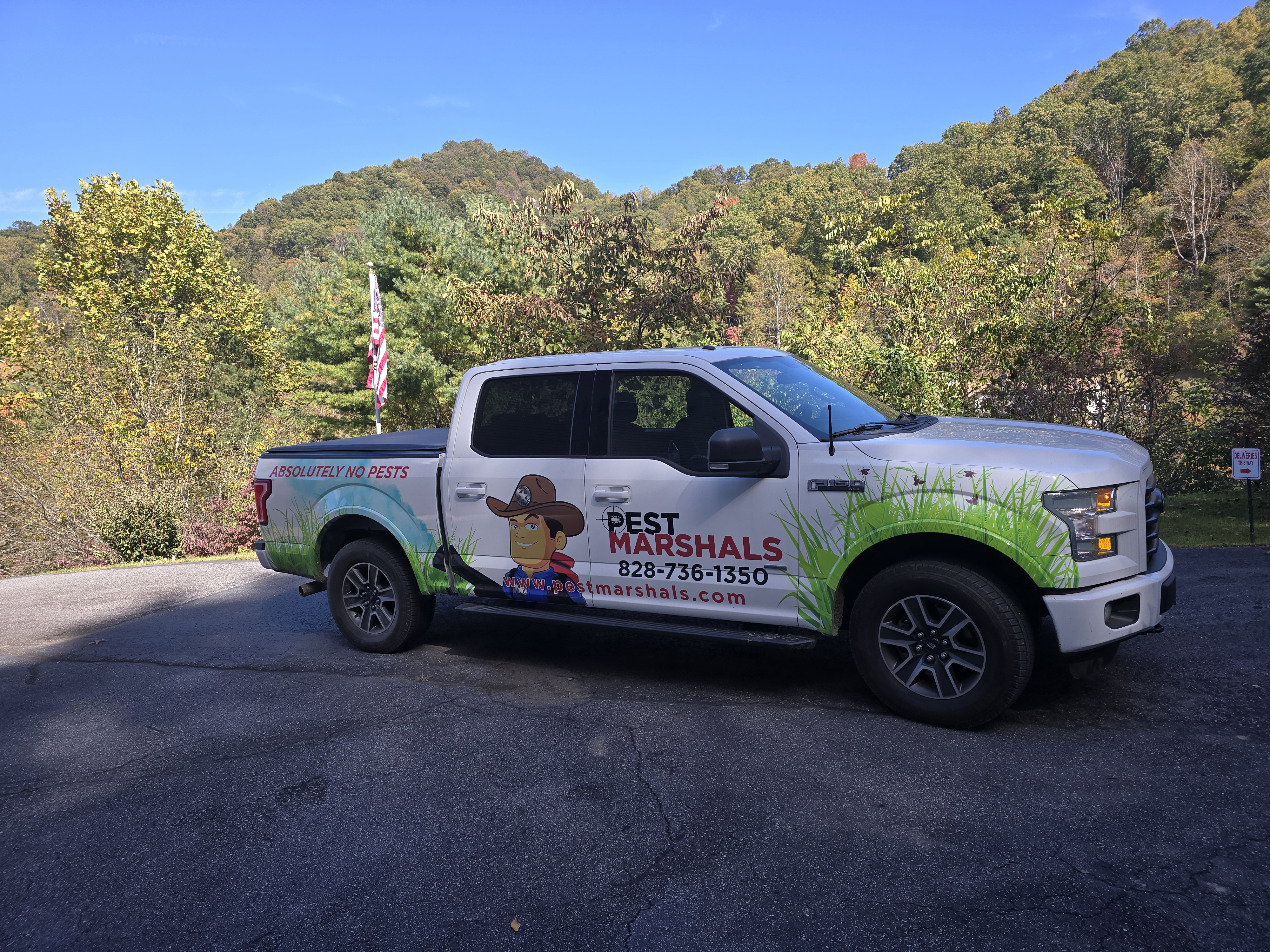 Pest Marshals truck with fall mountain foliage in Western NC